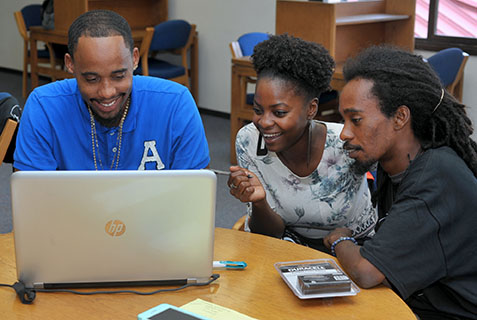 Terrance Emmanuel, Leanne Morancie and Geron Richards strategize at HackFest.